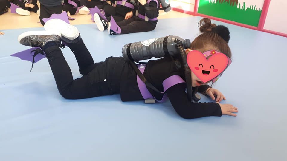 Una niña está acostada en el suelo con un equipo de buceo.