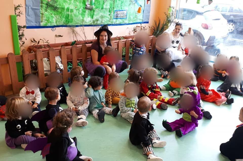 Un grupo de niños está sentado en el suelo de una habitación.