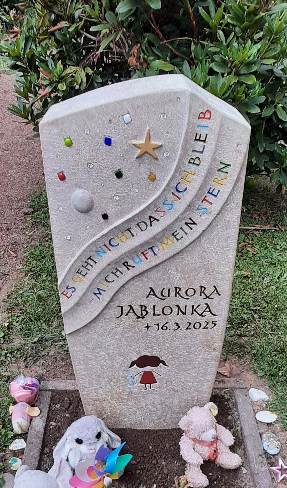 Helles Kindergrabmal mit Sternsymbol und farbigen Glaselementen