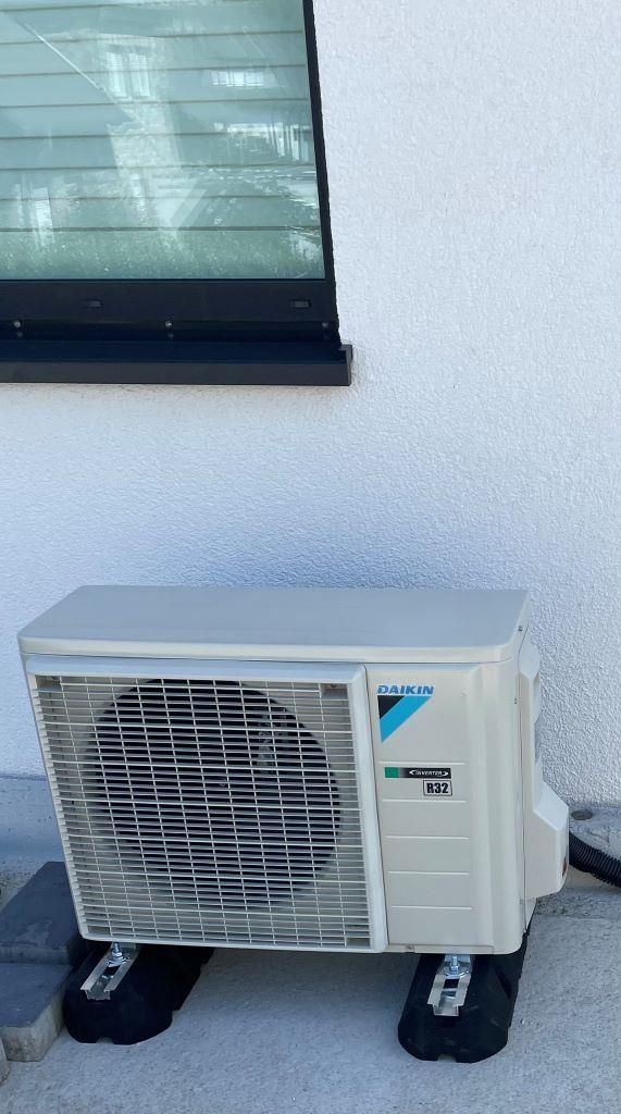 Eine Daikin-Klimaanlage steht draußen neben einem Fenster