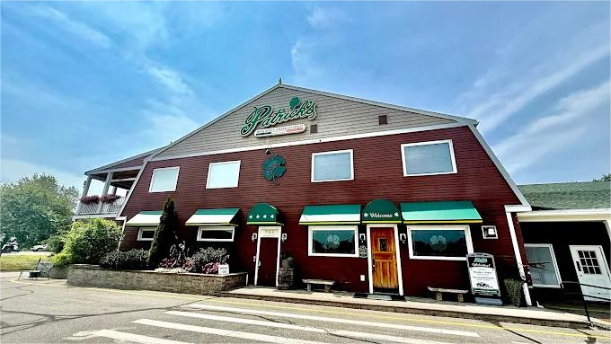 A two-story red building with green awnings.