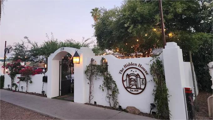 White stucco wall with arched entrance to 