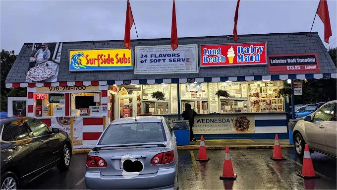 Food stand with various signs, including