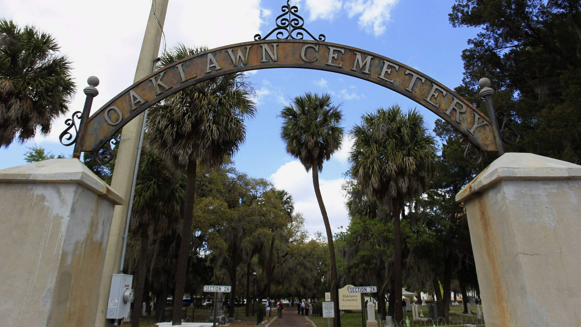 Oaklawn Cemetery entrance archway. Metal sign reads