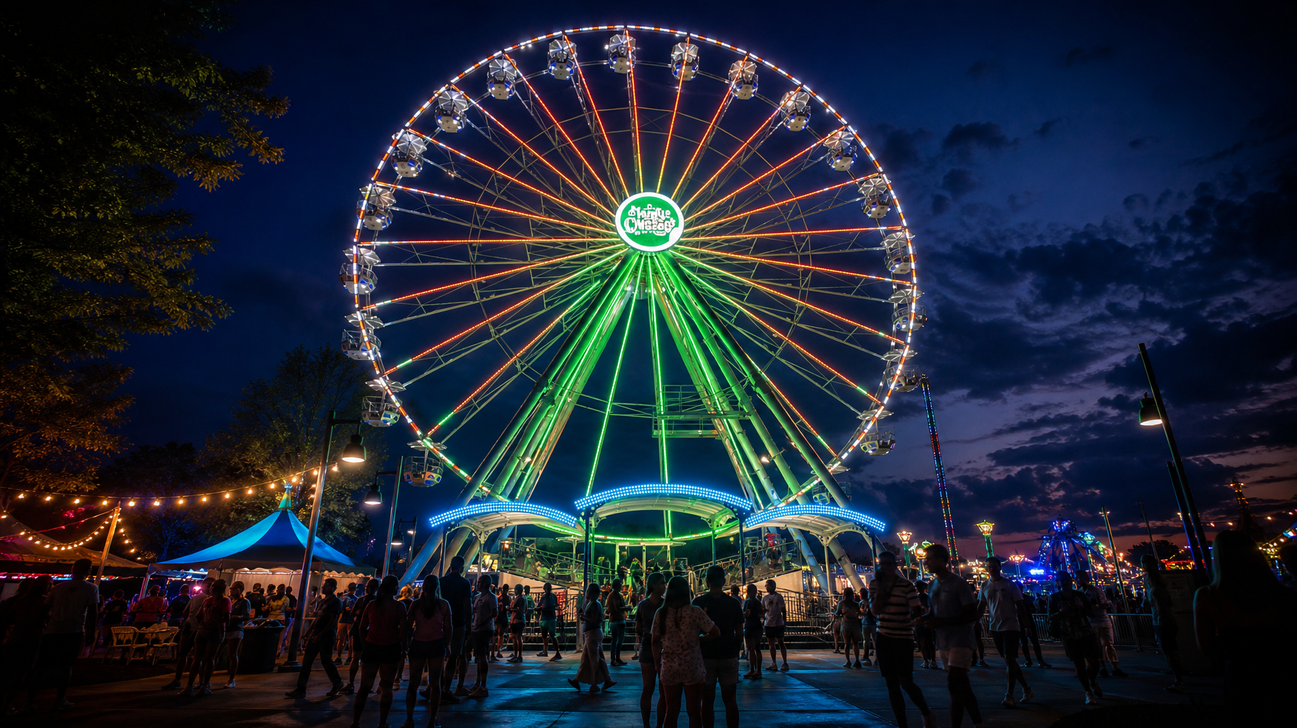 Night carnival with a brightly lit Ferris wheel glowing green, red, and white above a crowd at dusk