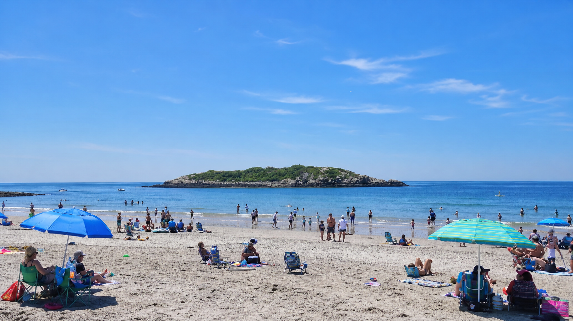 Sunny beach with people relaxing under umbrellas and a small island in the distance.