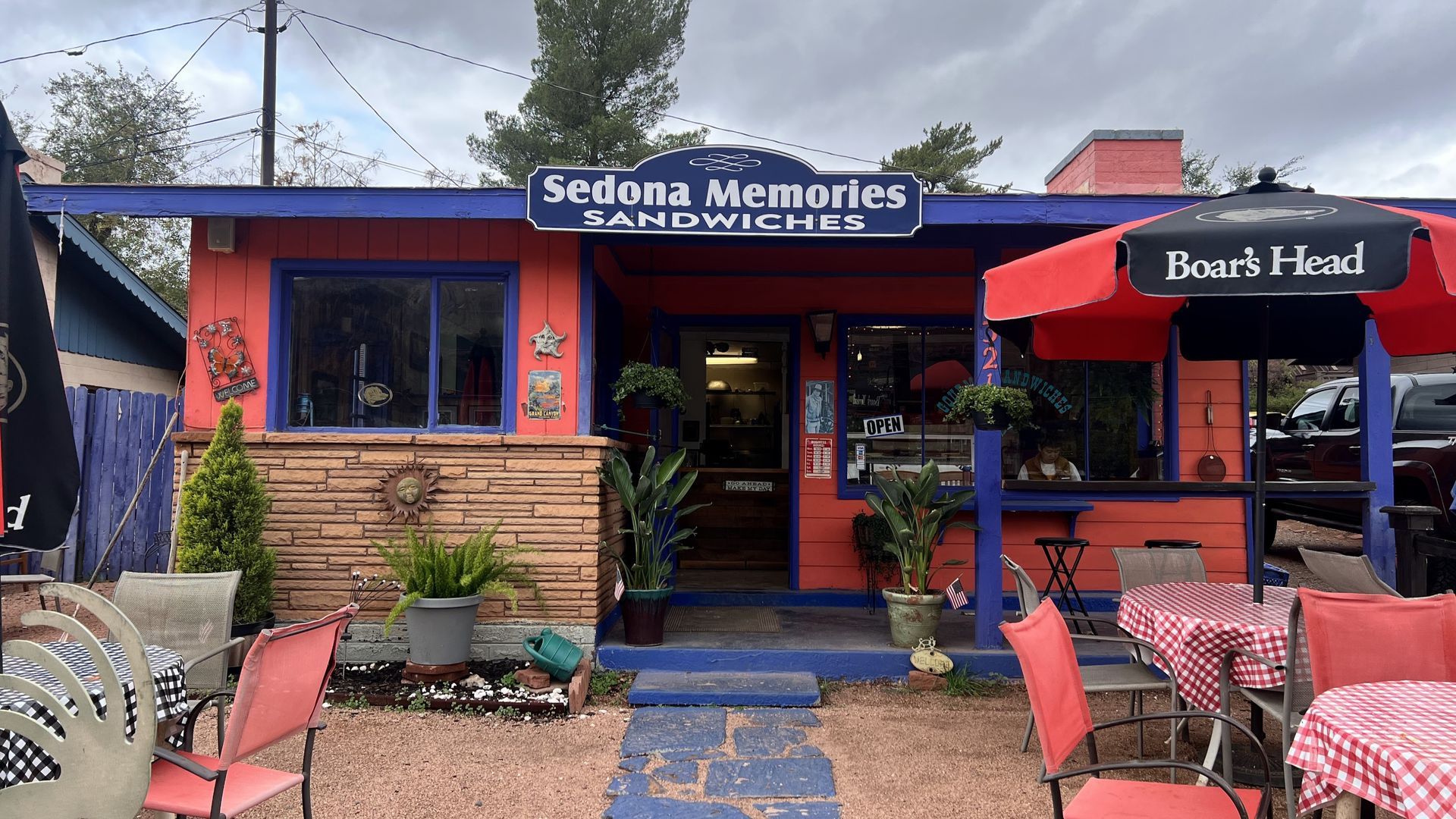 Sedona Memories sandwich shop with red and blue exterior, outdoor seating, and sign.