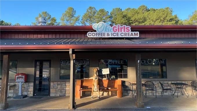 Ok Girls Coffee & Ice Cream shop exterior with red awning and wooden bench.