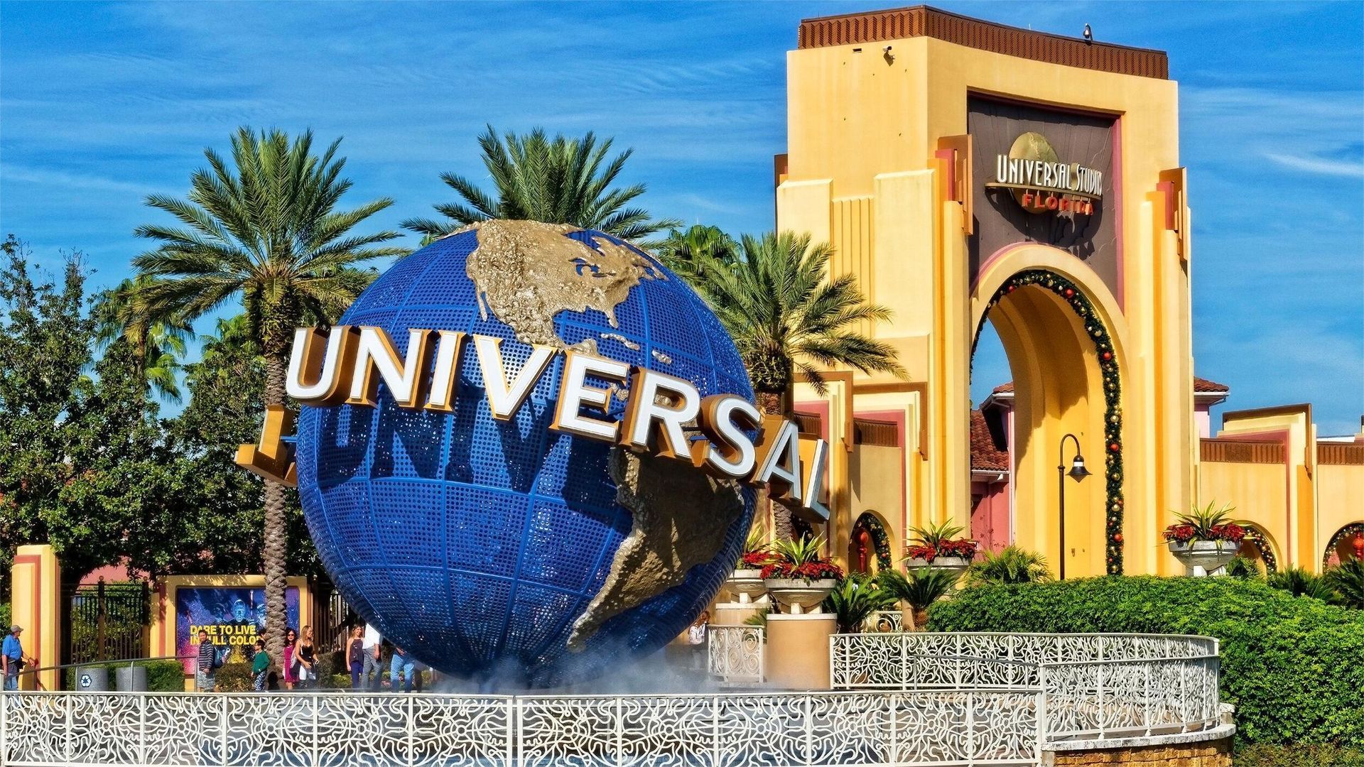 Universal Studios globe and entrance under a sunny sky.