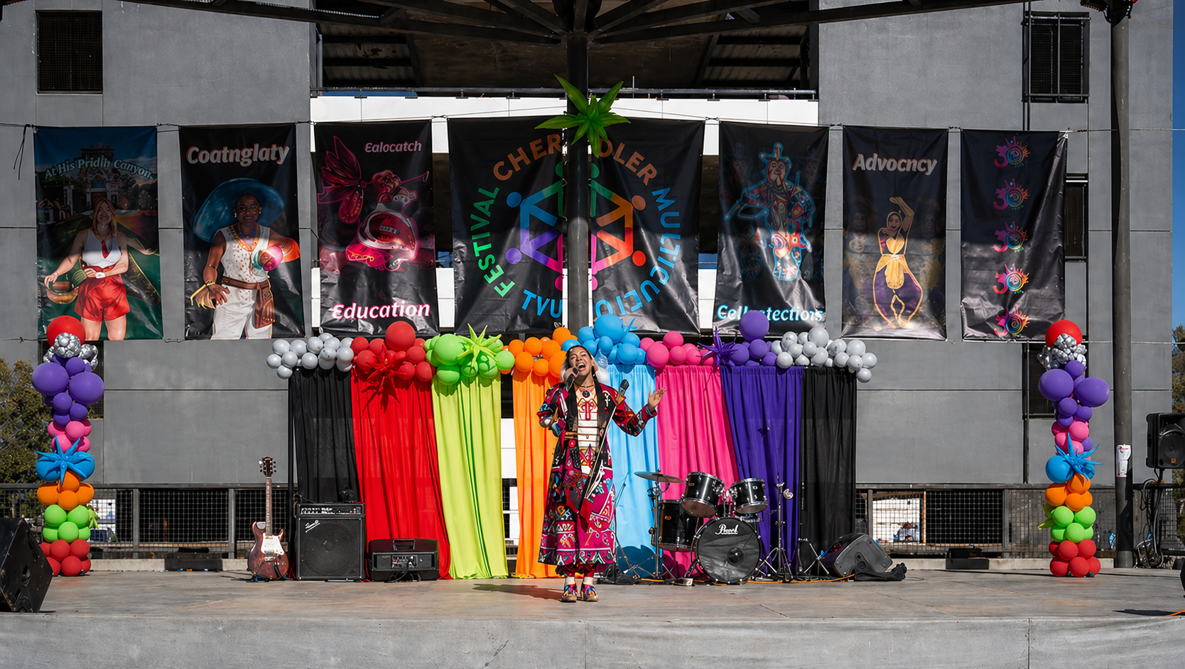 Storefront display of colorful wigs and costumes hanging in front of a shop window