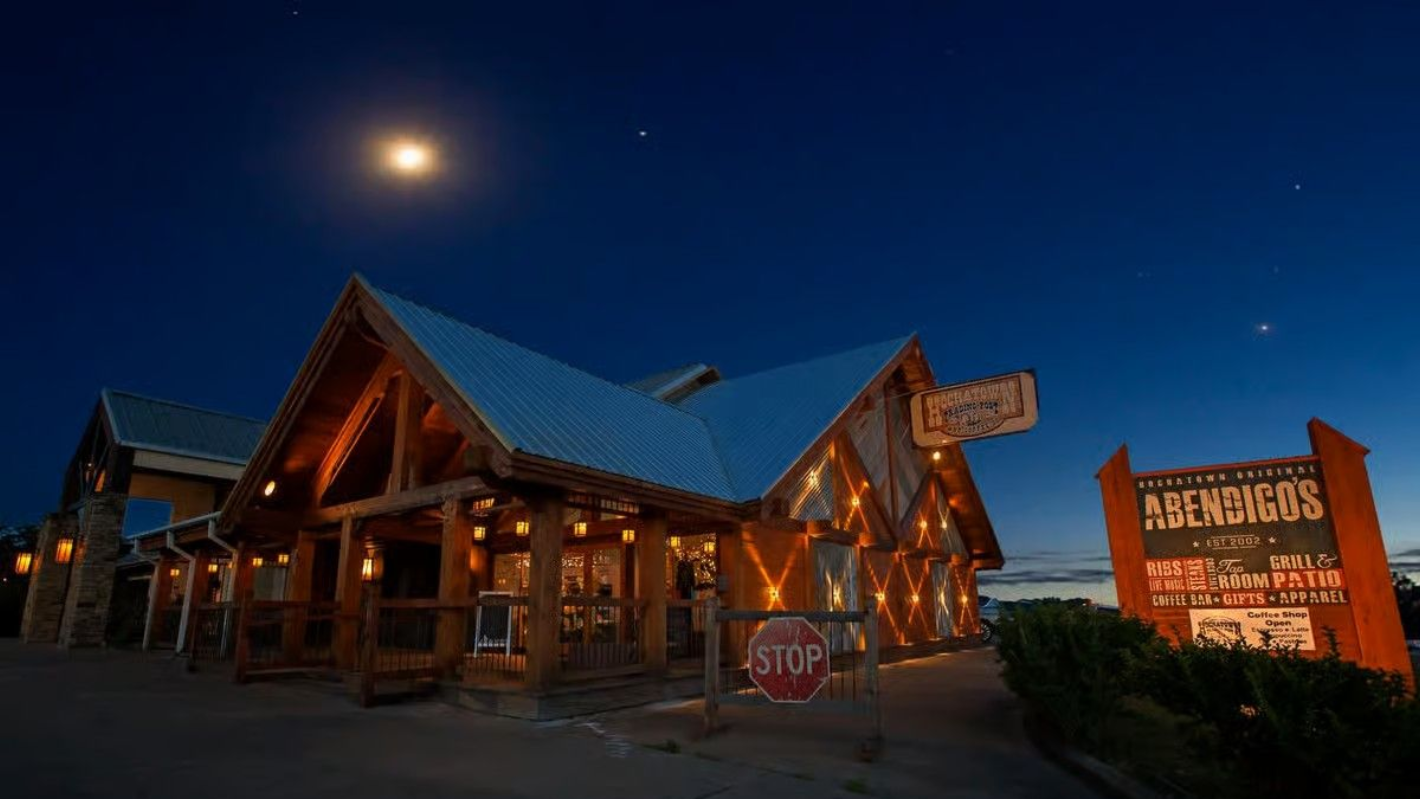 Abernathy's restaurant at night; rustic wooden building with lighted sign under a moonlit sky.