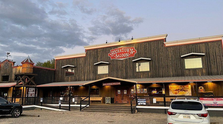 Western-themed building with a wooden facade, sign reading