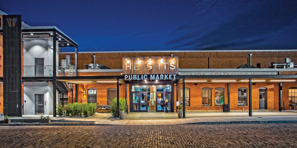 Brick building with lit sign that says
