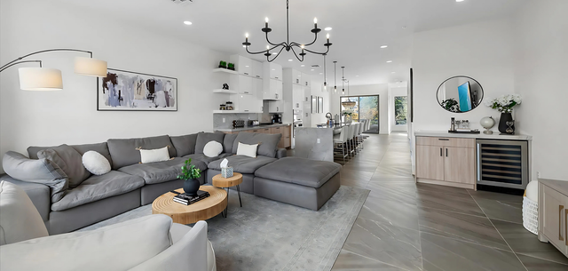 A living room filled with furniture and a large sectional couch.