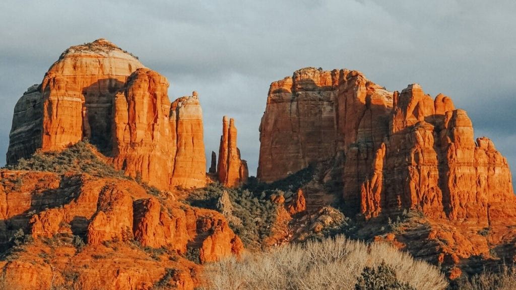 Red rock formations against a cloudy sky in Sedona, Arizona.