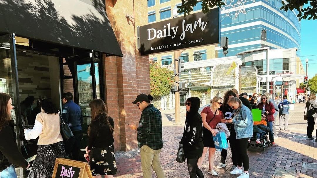 People line up outside a cafe, 