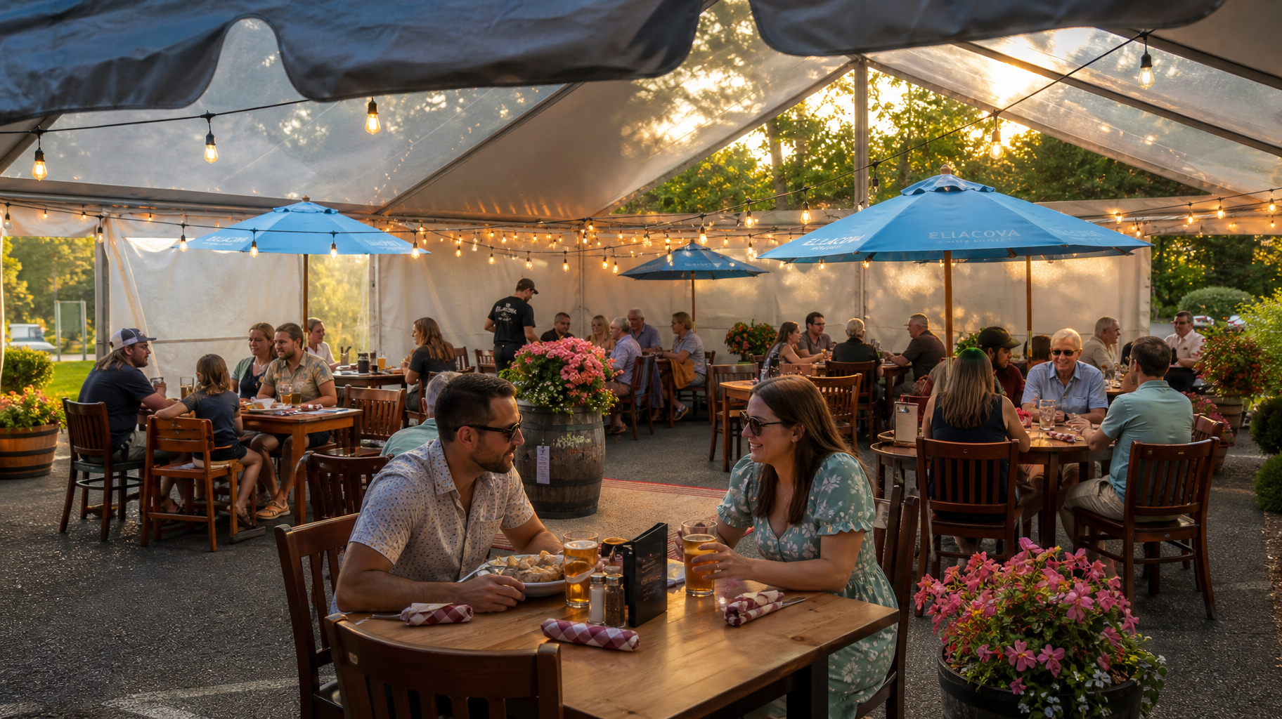 Outdoor café under a tent with diners at wooden tables, blue umbrellas, and string lights at dusk