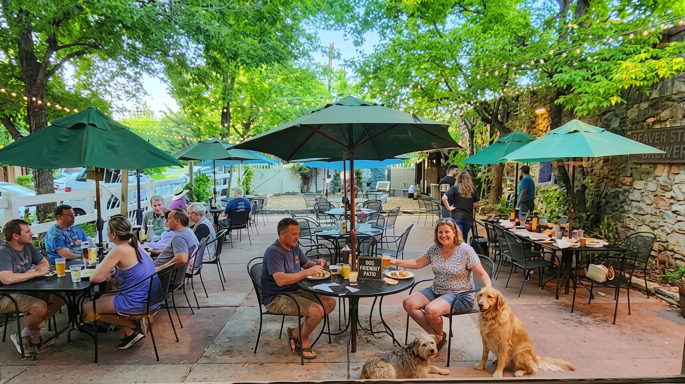 Outdoor café patio with green umbrellas, seated diners, and a dog resting beside a table
