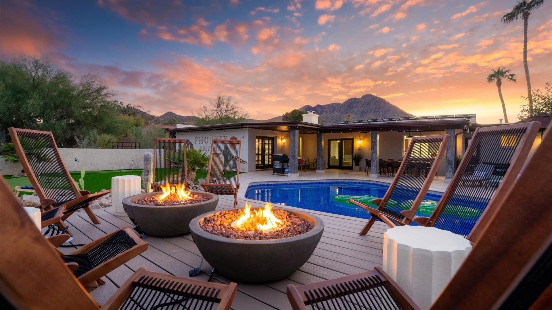 Poolside fireside retreat at sunset Private poolside firepit area with luxury seating, mountain views, and colorful sunset skies