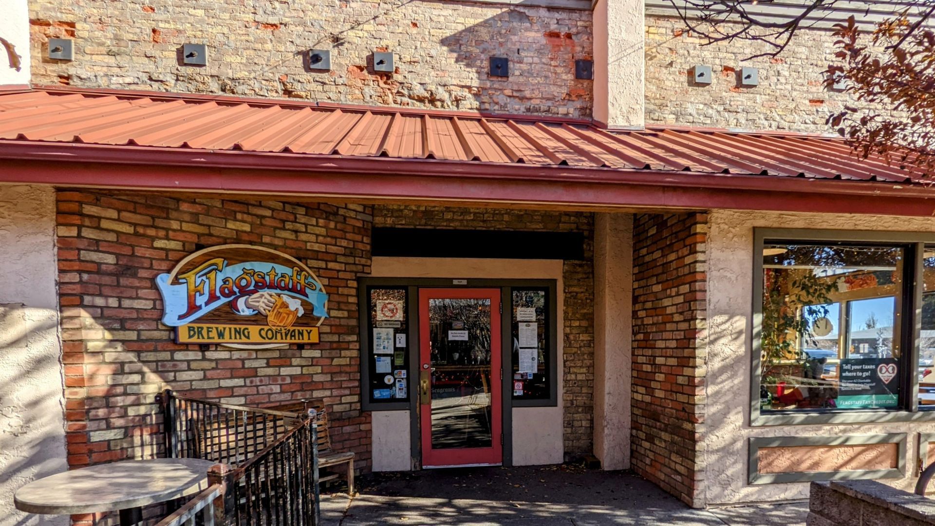 Cafe entrance with brick facade and red awning; logo on left: The Bean Scene.