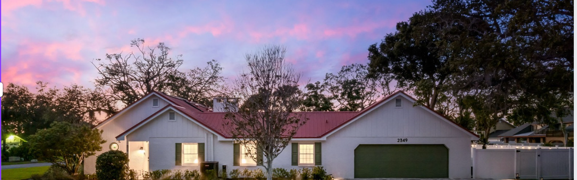 Luxury rental home exterior at dusk Exterior view of a luxury short-term rental property at sunset