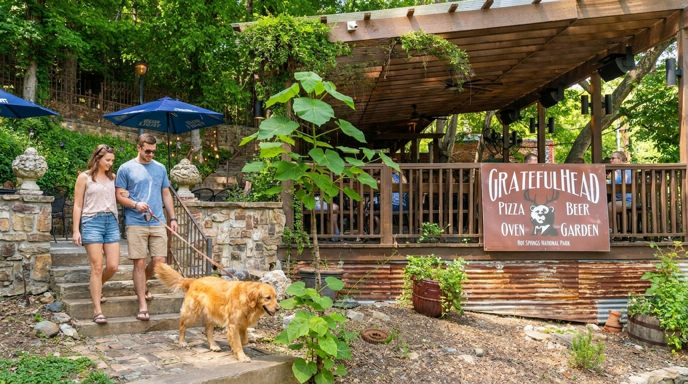 Couple walking a golden dog past a rustic café sign in a lush garden setting