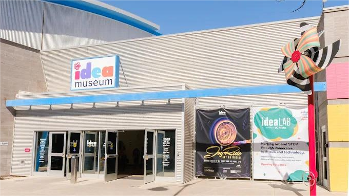 Exterior view of the Idea Museum with open doors. Signage includes