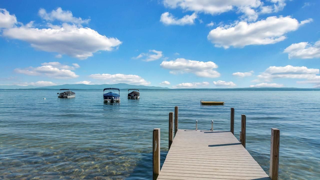 Dock Access New Hampshire STR Private dock with pontoon boats on New Hampshire lake, ideal for short-term rental guests.