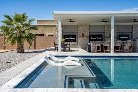 Modern backyard pool with white lounge chairs, palm tree, and shaded patio seating area