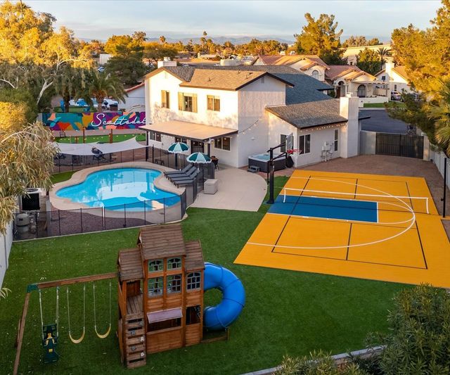 vacation home with luxury amenities like a tennis court and a pool, kids playground and more