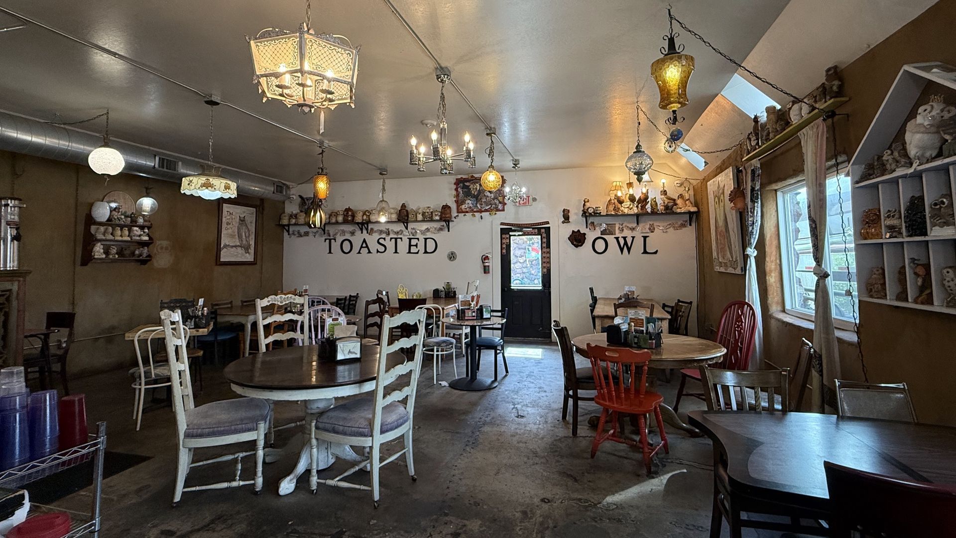 Interior of a cafe, tables and chairs, decorative lighting, 
