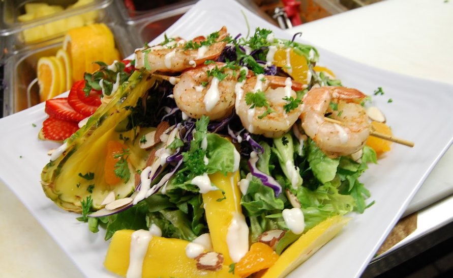 Shrimp skewers on salad dish 