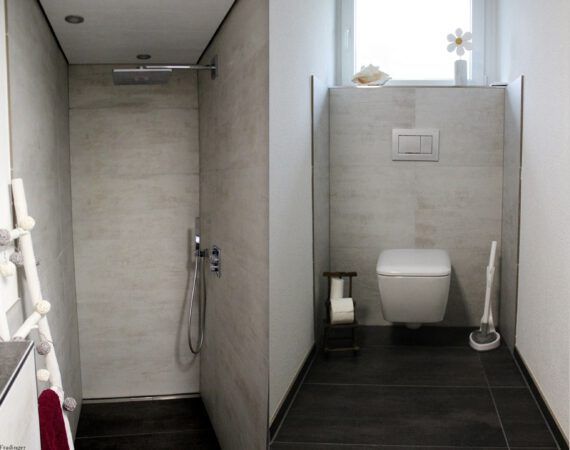 Modernes Badezimmer mit Dusche und WC, graue Wände, dunkler Boden.