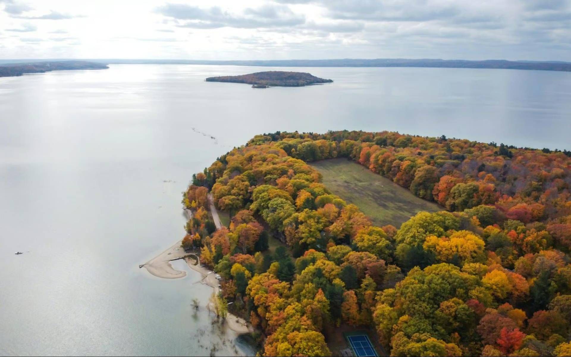 An aerial view of a lake with a small island in the middle