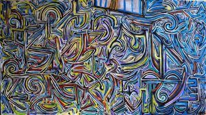 Obra de arte abstracta con líneas y formas en espiral en azul, amarillo, verde y morado.