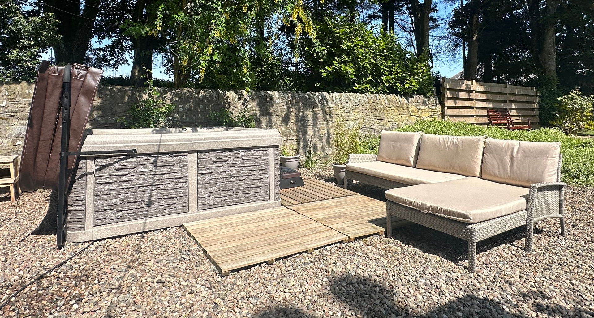 Outdoor seating area beside a hot tub