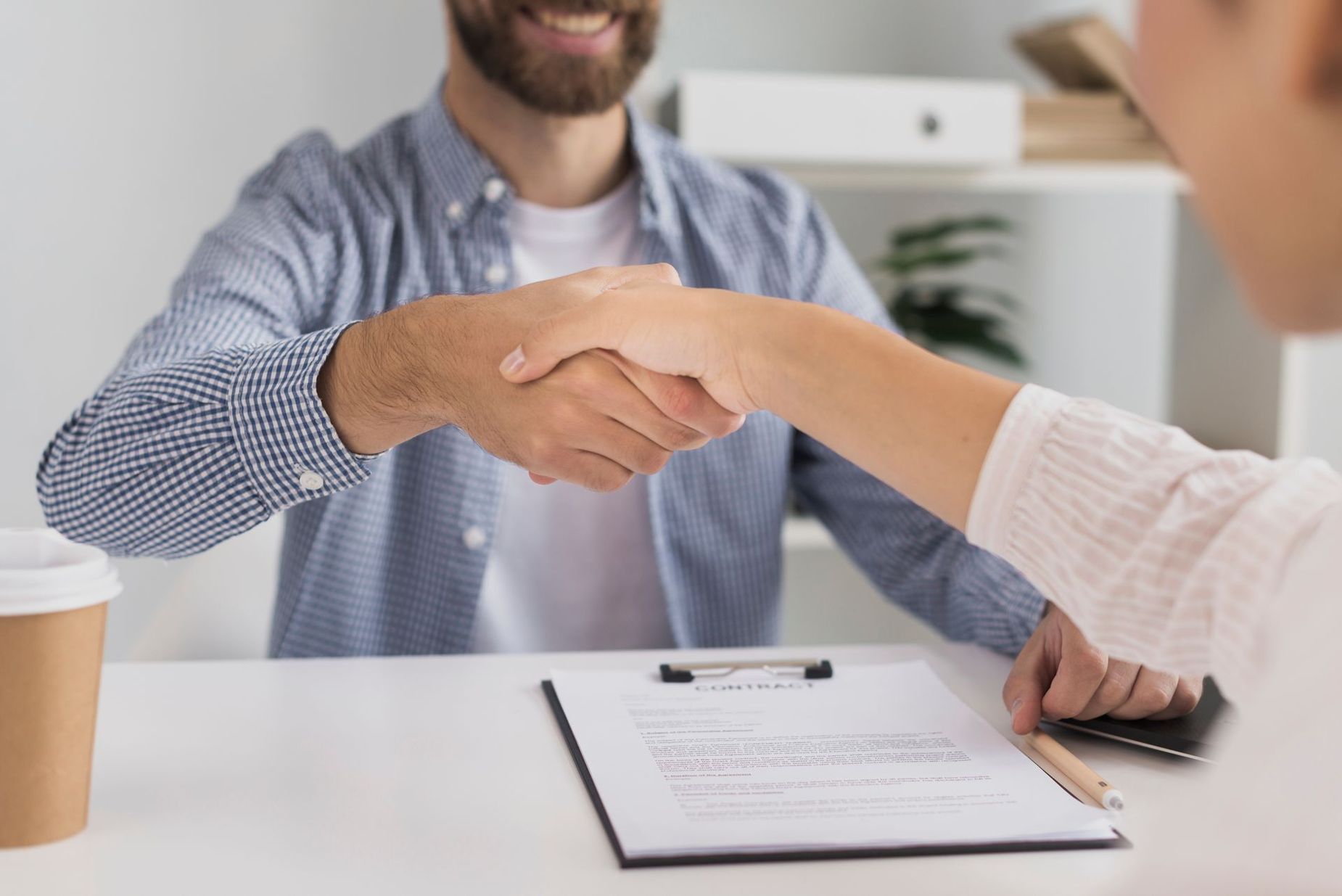 Firma de contrato entre dos personas en una oficina como acuerdo profesional