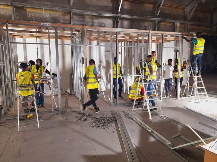 Um grupo de trabalhadores da construção civil está trabalhando em um edifício