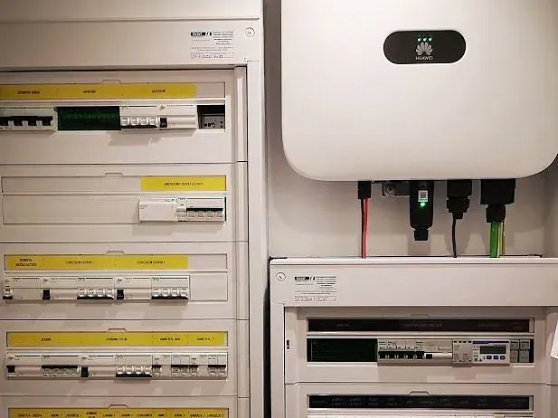 Una caja eléctrica blanca con un panel solar encima.