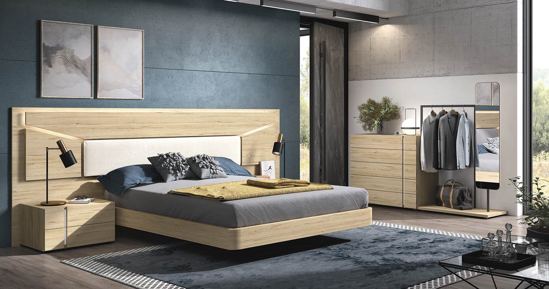 Un dormitorio con una cama, una cómoda, una mesita de noche y una alfombra.