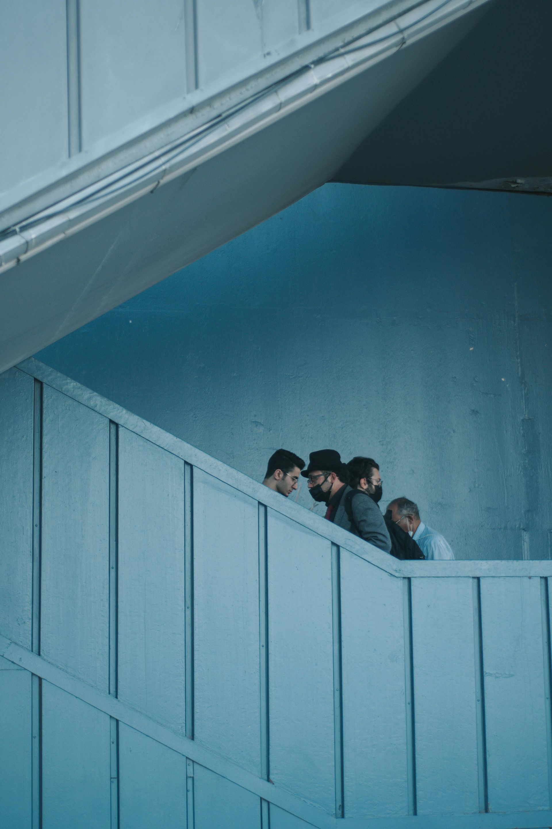 A group of men are walking up a set of stairs.