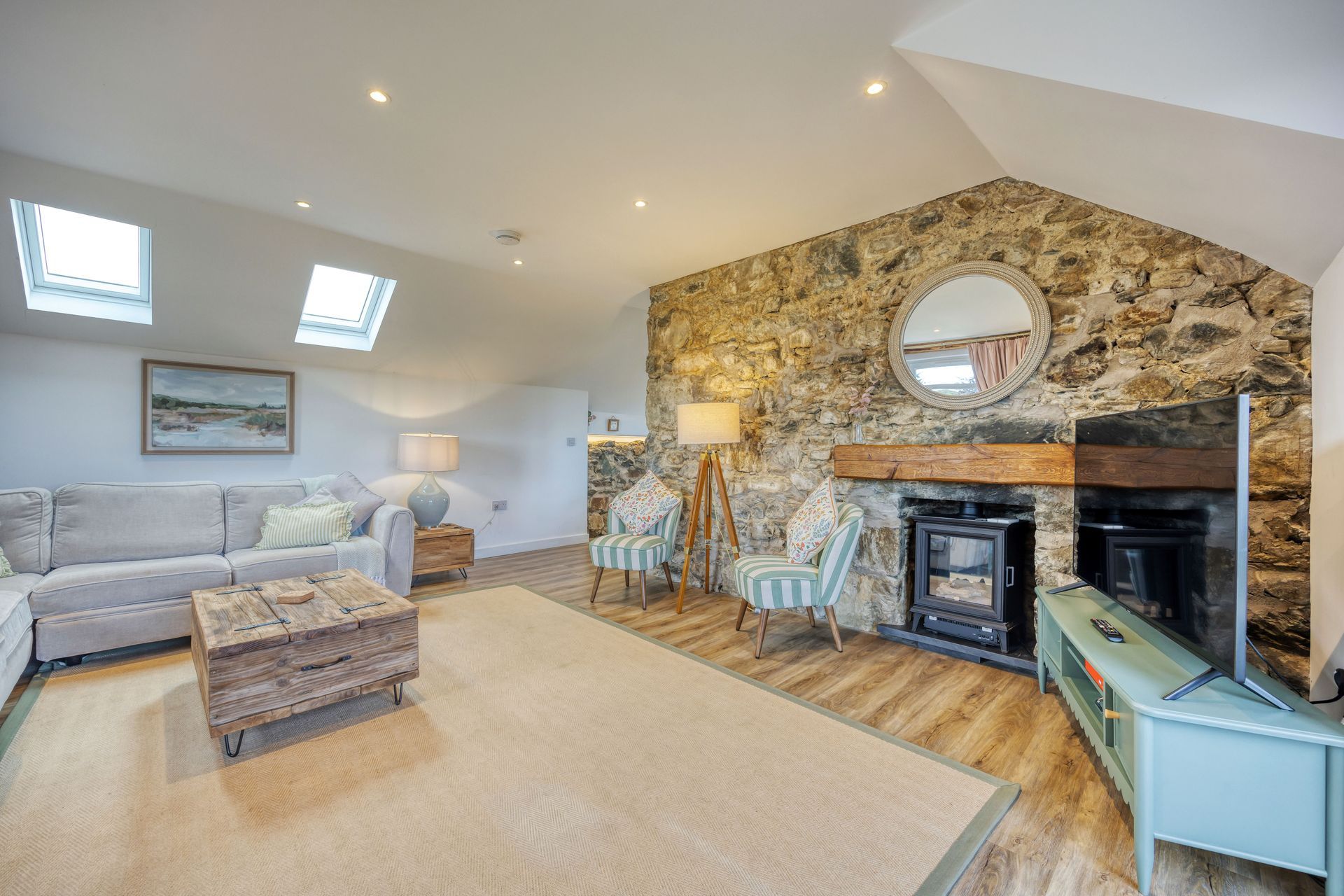 A living room with a couch , chairs , and a fireplace.