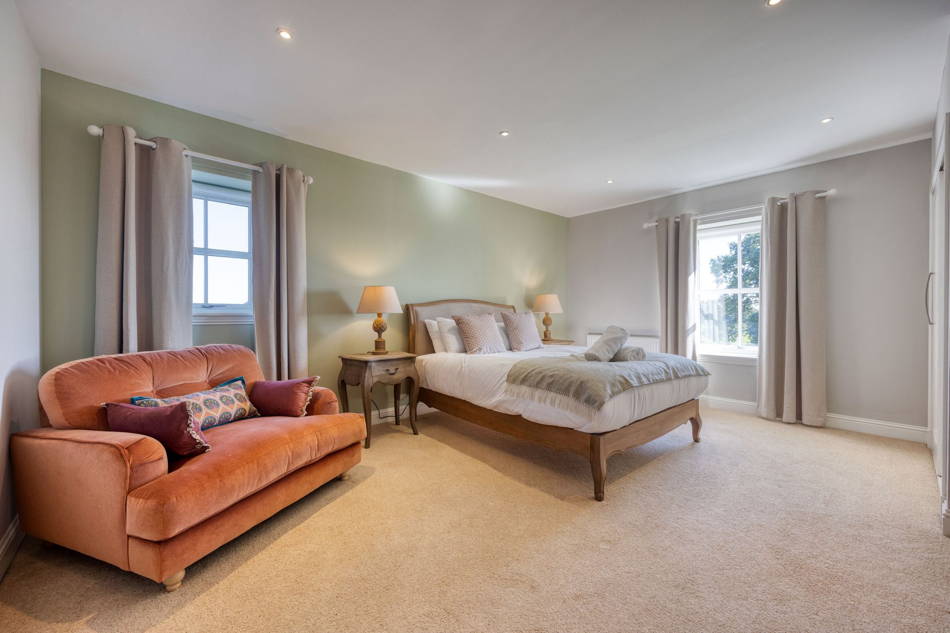 A bedroom with a bed , couch , and window.