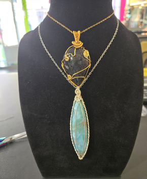 Collier en or avec un grand pendentif ovale sur un buste.