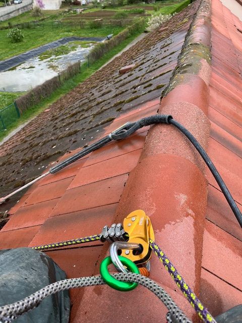 Le toit est nettoyé au nettoyeur haute pression, créant un nuage de brume.