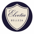 Logotipo circular con un escudo color crema sobre fondo azul marino. El escudo dice "Elvetia BELLEZA" en letra cursiva.