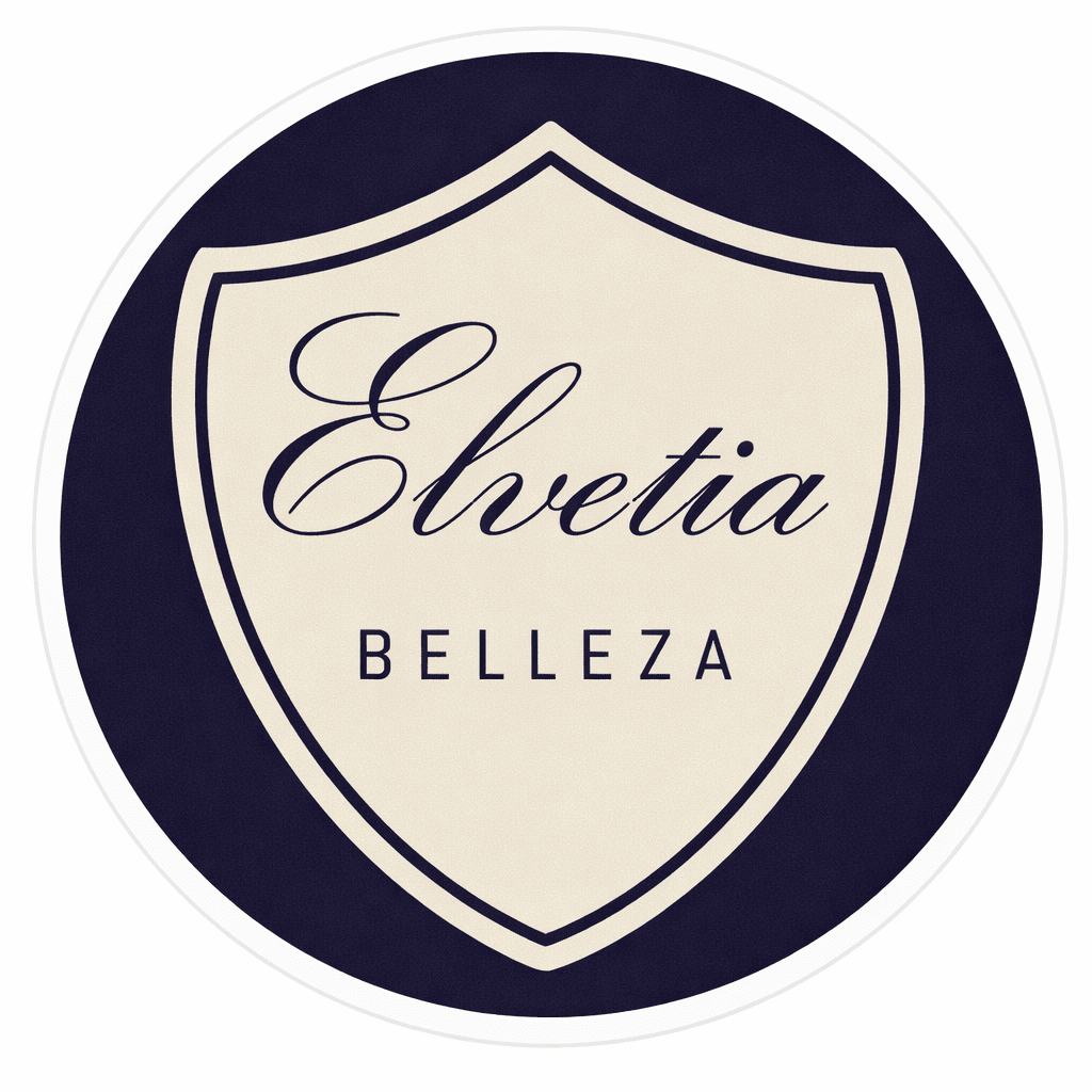 Logotipo circular con un escudo color crema sobre fondo azul marino. El escudo dice "Elvetia BELLEZA" en letra cursiva.
