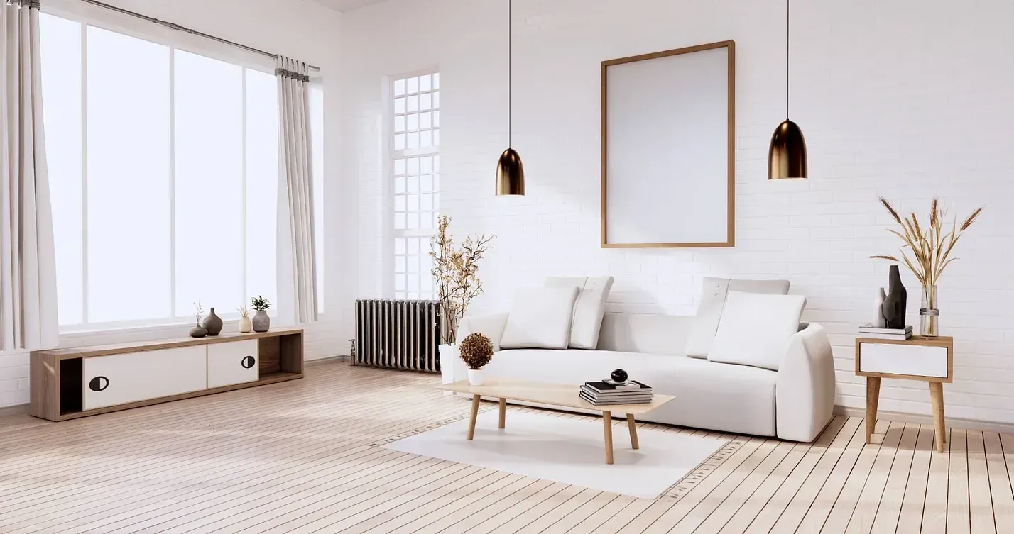 Una sala de estar con un sofá blanco y una mesa de madera.