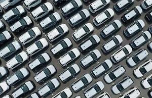 Un montón de coches están estacionados en un estacionamiento.