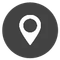 Un icono de pin blanco en un círculo negro sobre un fondo blanco.